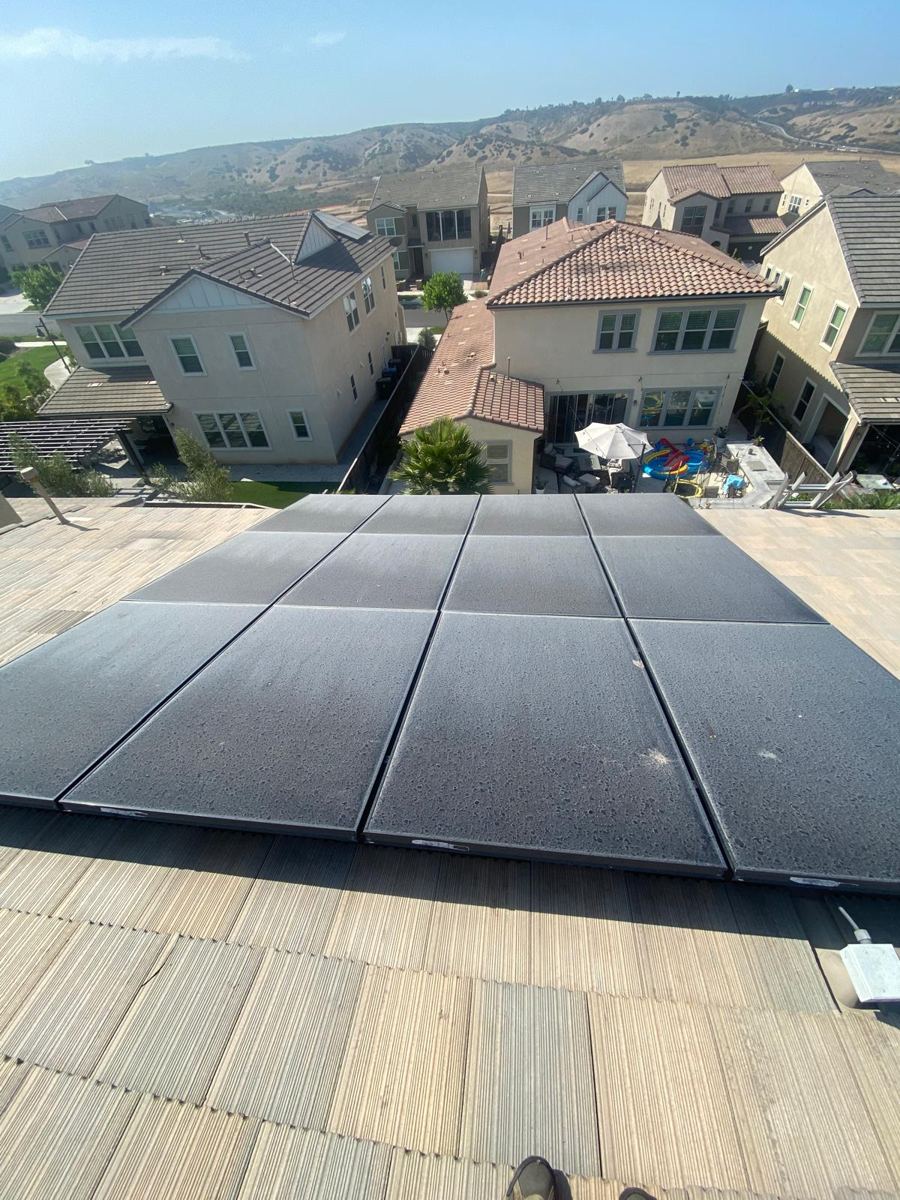 Dirty solar panels on a tile roof, before cleaning