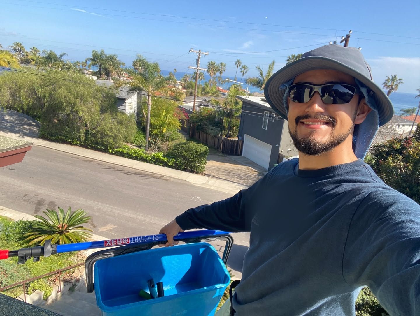 Tony from Campista on a San Diego rooftop with his water-fed pole and bucket