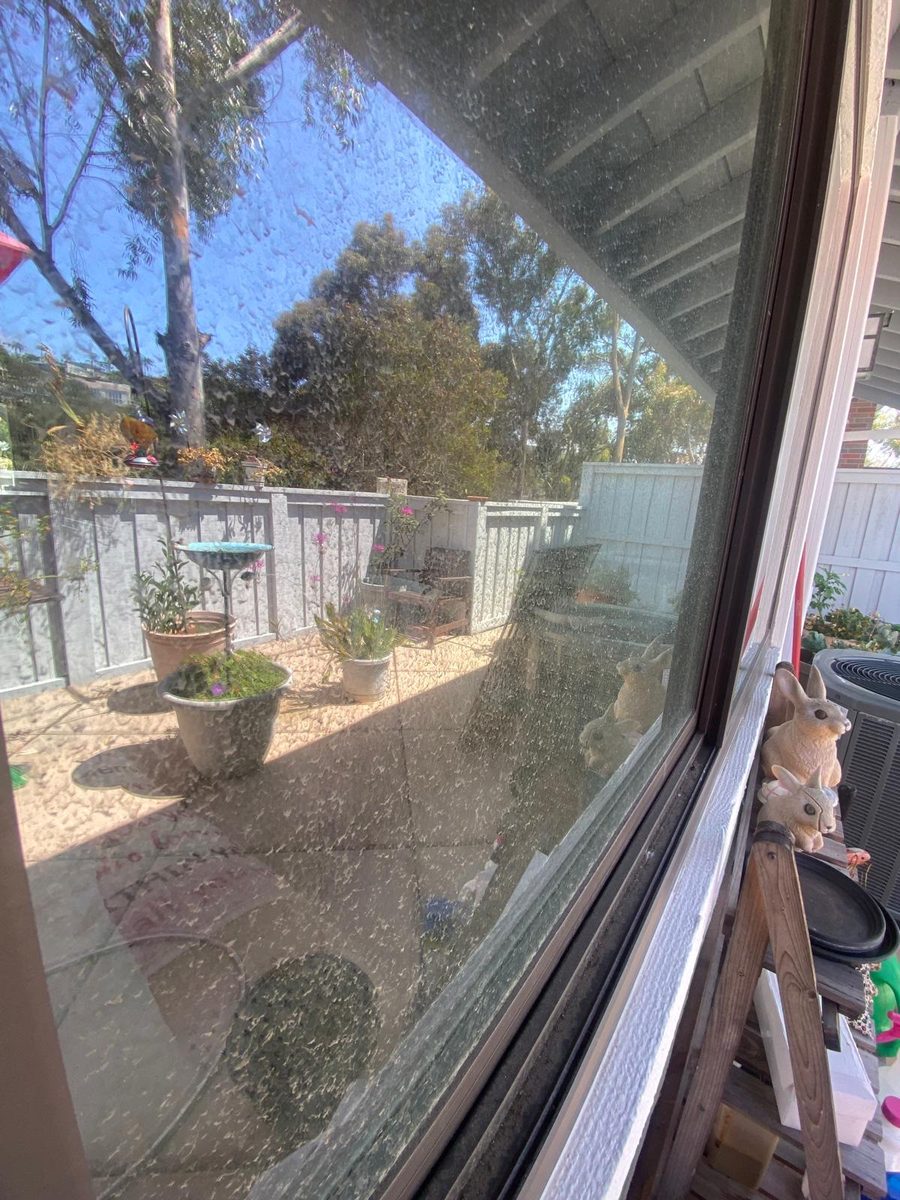 Patio window covered in water spots, before cleaning